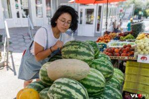 Женщина стучит по арбузу